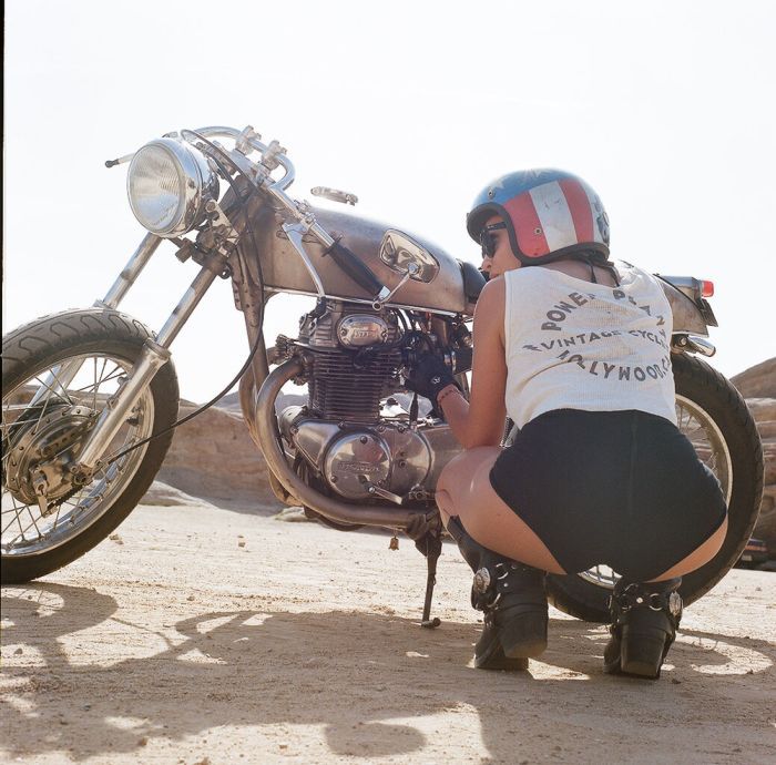 A playful frame from Girls on a motorcycle — online in Belford Roche